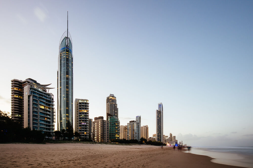 View from beach as sun sets behind Broadbeach