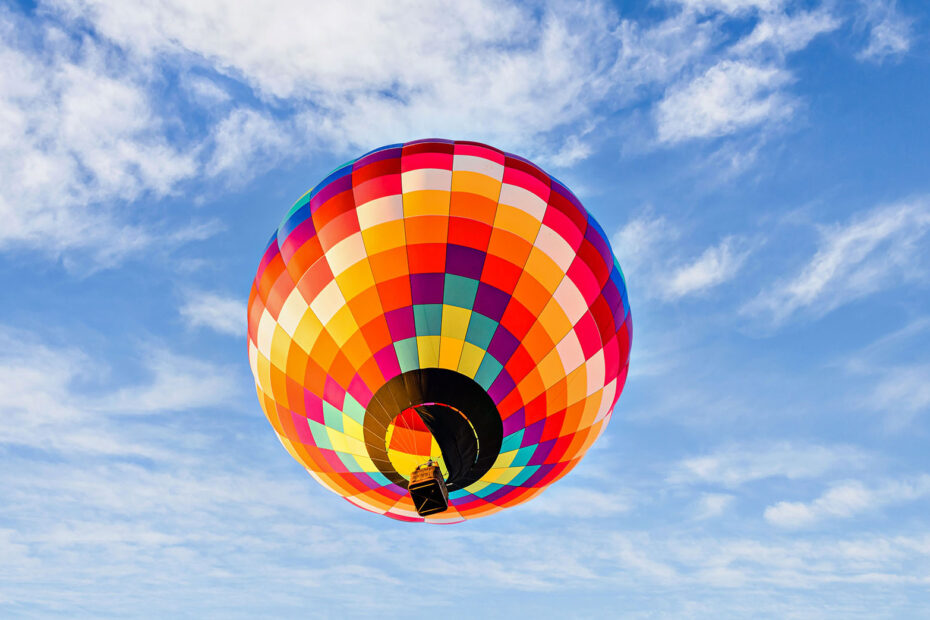 Colourful hot air balloon flying overhead