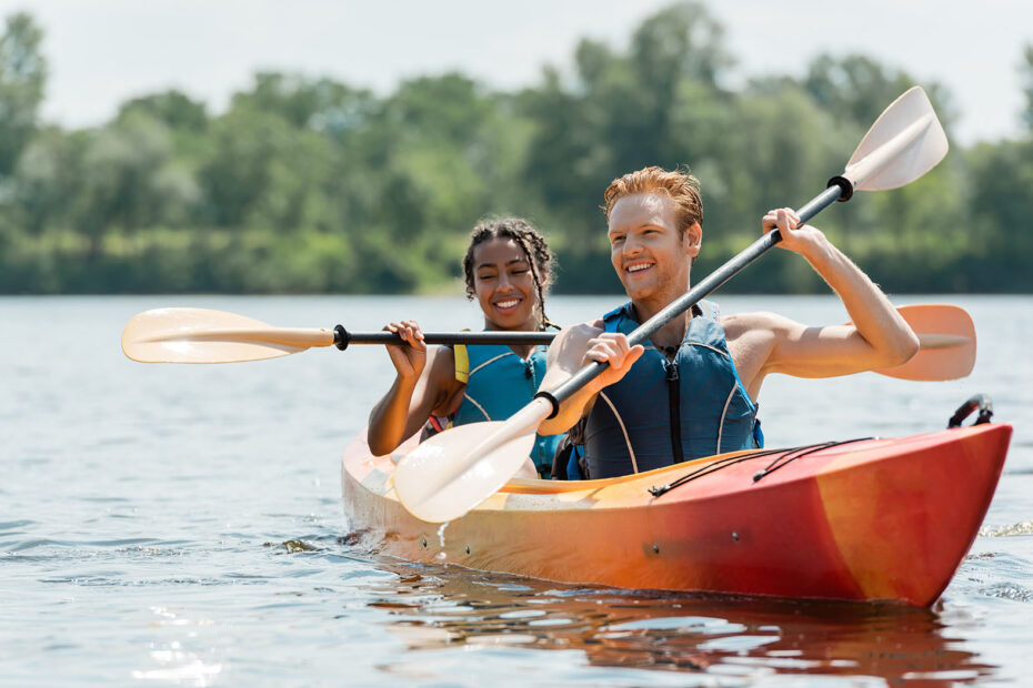 Two young people paddling a kayak