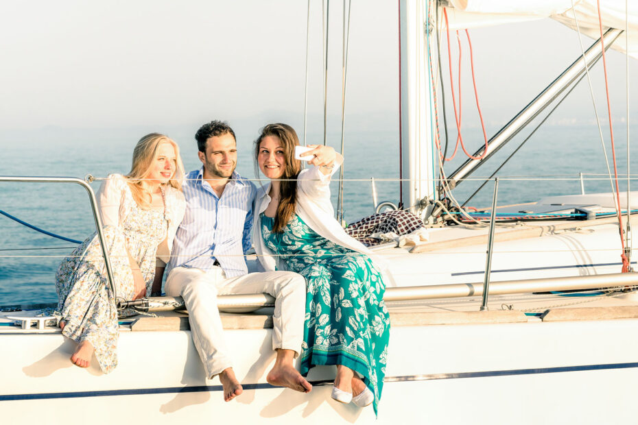 Three people taking a selfie on a yacht