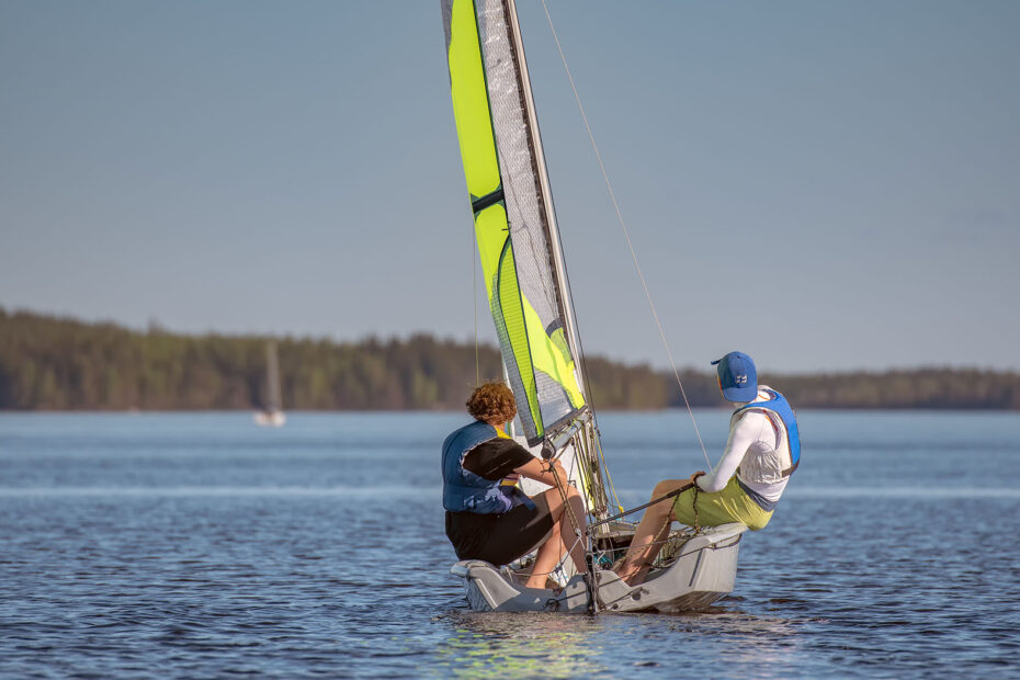 Young men sailing with their dinghy