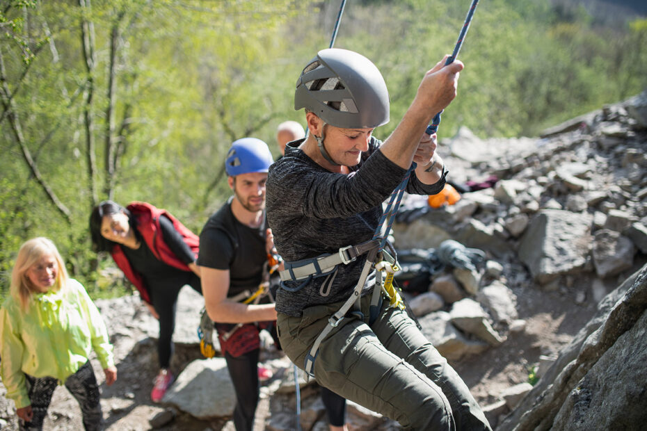 People rock climbing and abseiling